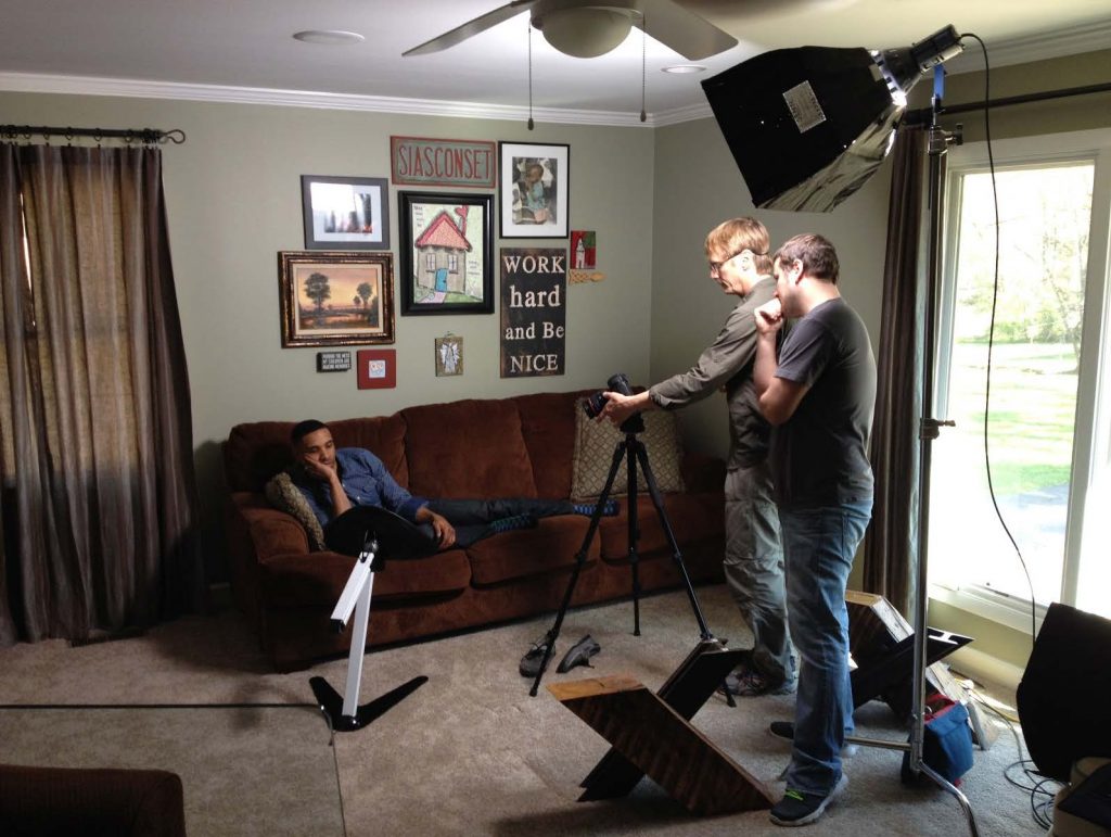 Camera man in home filming a person talking about their Kickstarter campaign