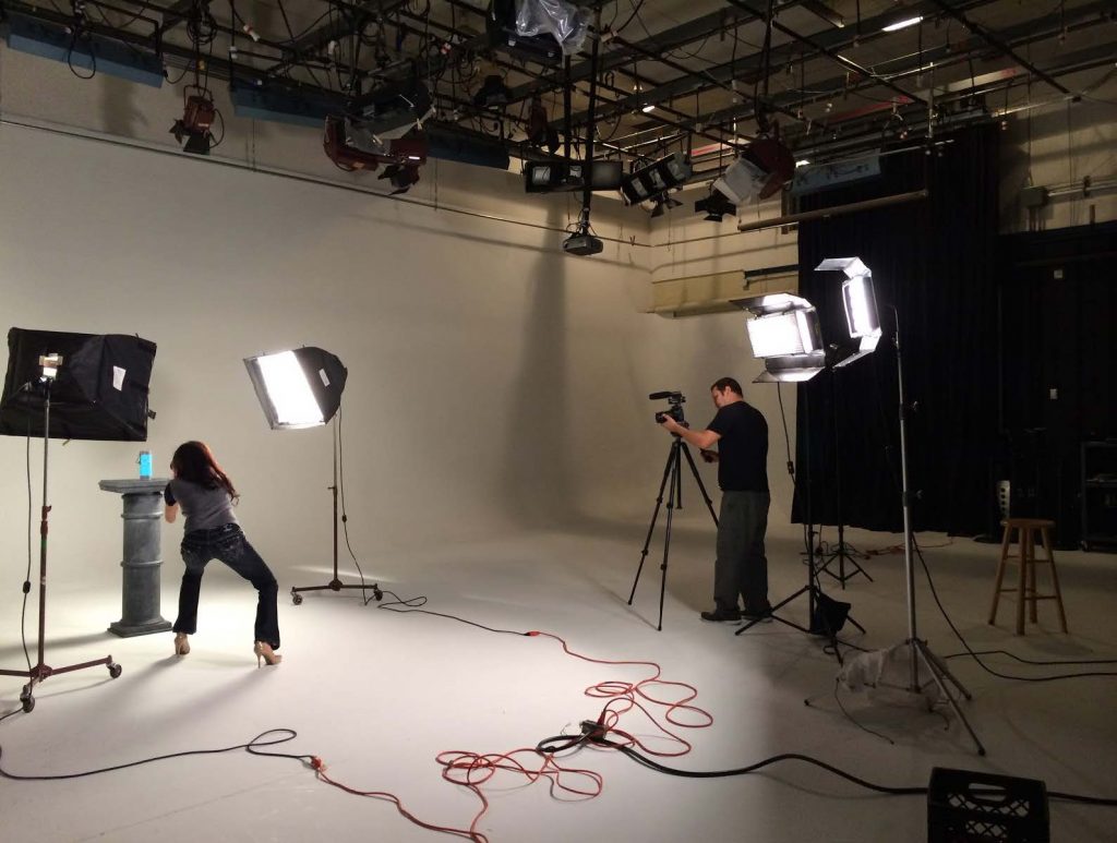 Video crew in a white studio filming product shots of a crowdfunding product