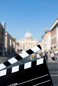 Movie clapper board with St Peter cathedral view out of focus in background