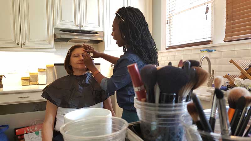 Hair and Makeup behind the scenes woman getting hair and makeup done before being filmed